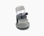 Joseph Joseph Palm Scrub Grey indų plovimo &scaron;epetys su integruotu muilo dozatoriumi