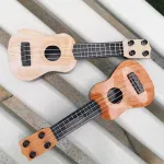 Mini ukulele žaislas vaikams, plastikinis gitaros žaislas, 4 stygos, muzikos instrumentas, realisti&scaron;kas modelis, 25 x 9 x 2.7 cm, &scaron;viesiai ruda