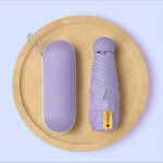 Mini kelioninis skėtis, kompakti&scaron;kas ir ne&scaron;iojamas nuo lietaus. ,  Violetinė pliusinė dėžutė
